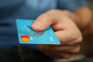 Man extending debit card