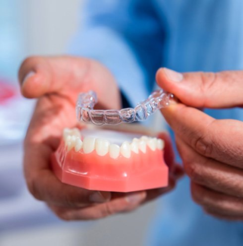 New Invisalign tray being removed from model teeth