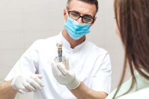 dentist discussing dental implant with patient