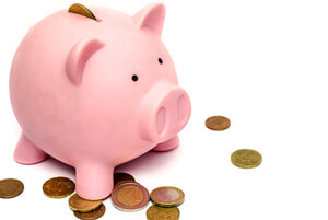 pink piggy bank and coins on white background