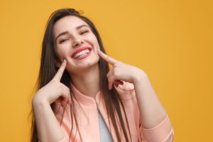 woman pointing to her teeth