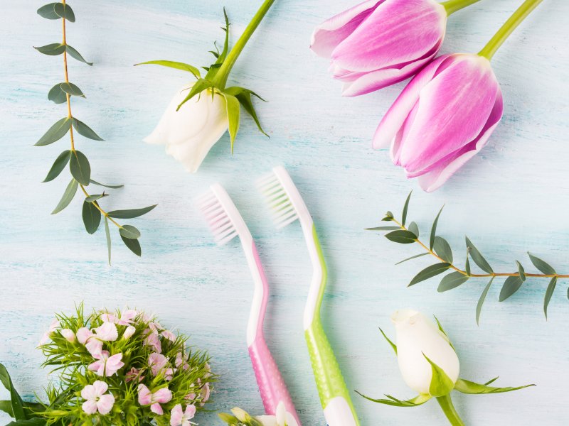 Two toothbrushes with flowers.