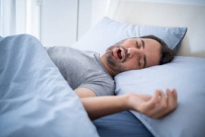 Snoring man in bed